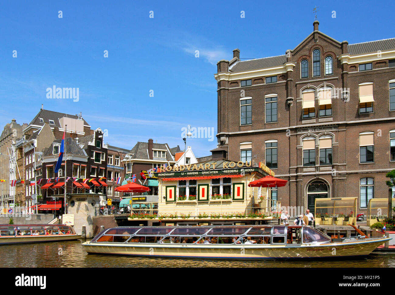 Image of a typical sightseeing boat in a water channel in the inner city of Amsterdam, Holland. Stock Photo