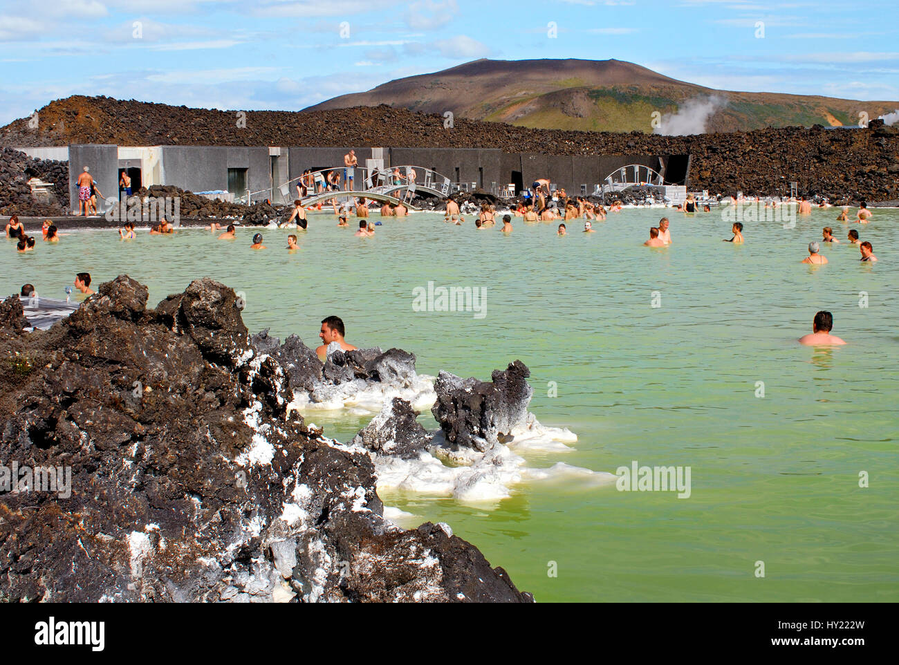 Stock Photo of locals and tourists enjoying  the public swimming pool at the Blue Lagoon in Iceland. Stock Photo