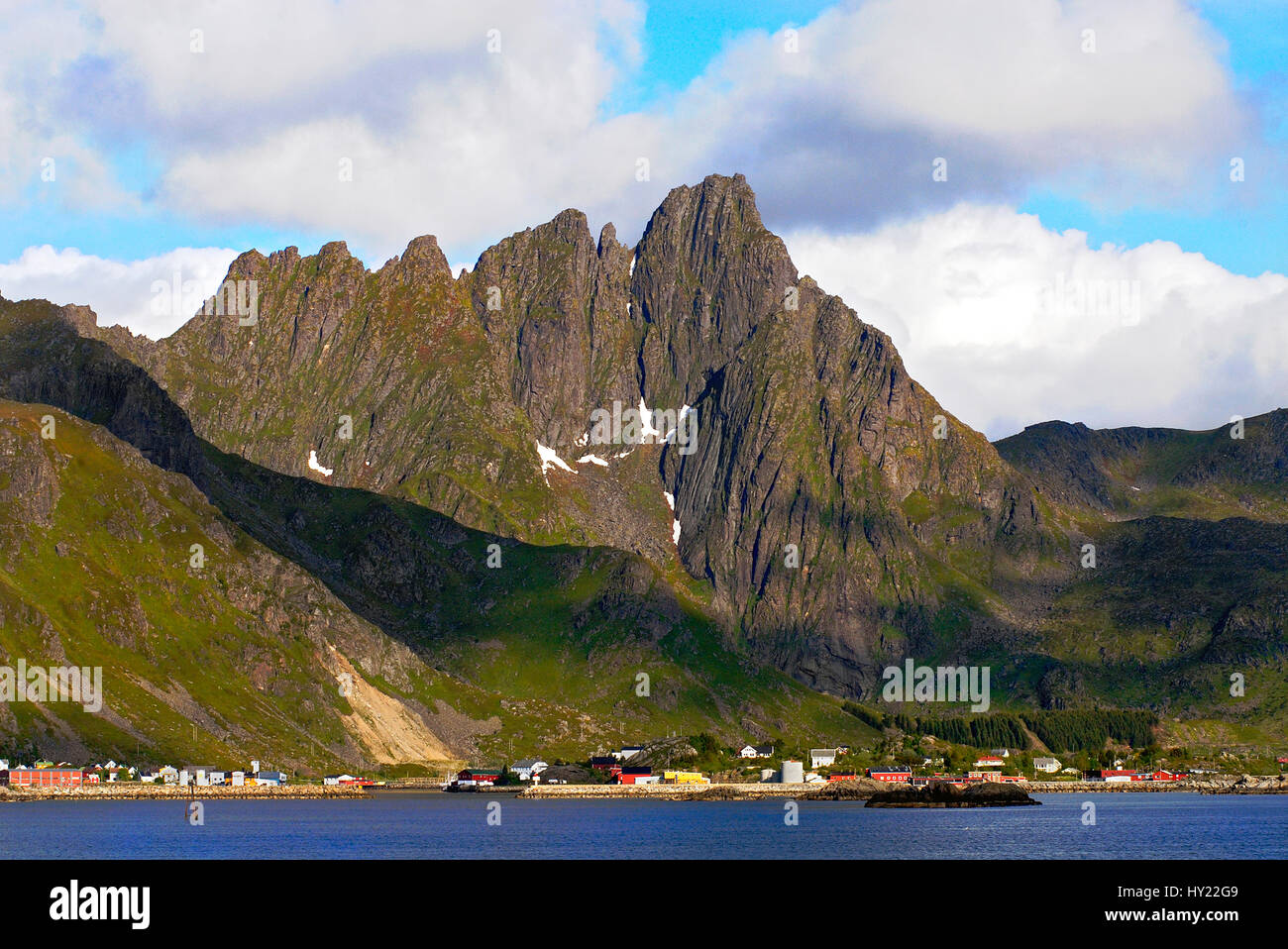 The image shows a spectacular MountainRange in at the Lofoten Islandof Vestvagoy that belong to Norway. Just below the mountain range at the coast is  Stock Photo