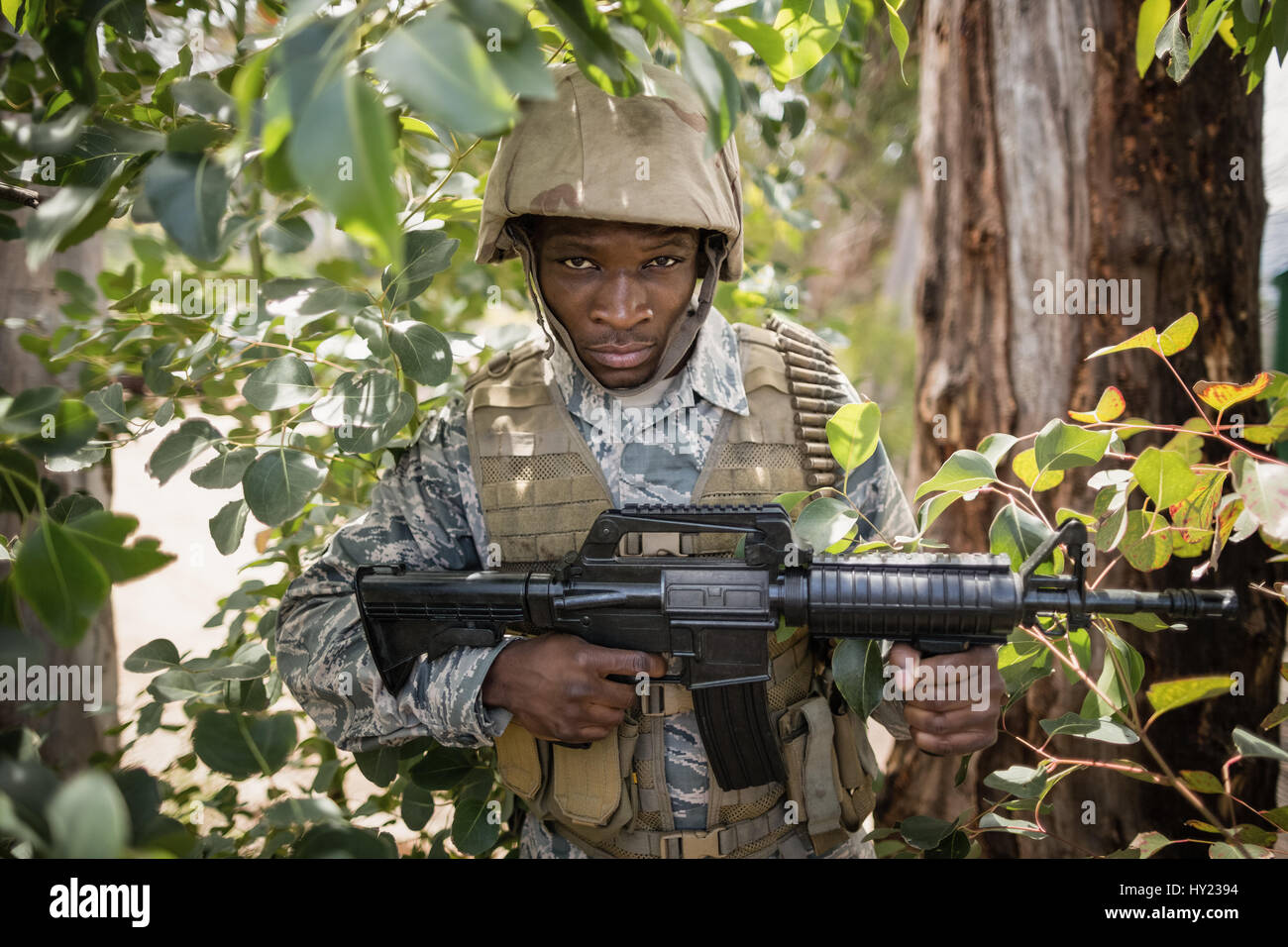 Portrait of confident military soldier guarding with a rifle in boot ...