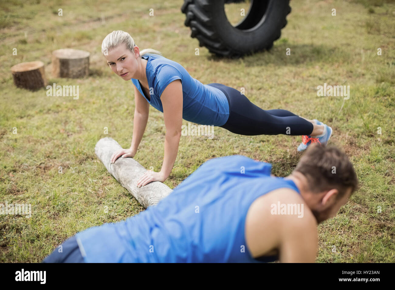 Fit people performing pushup exercise in boot camp Stock Photo