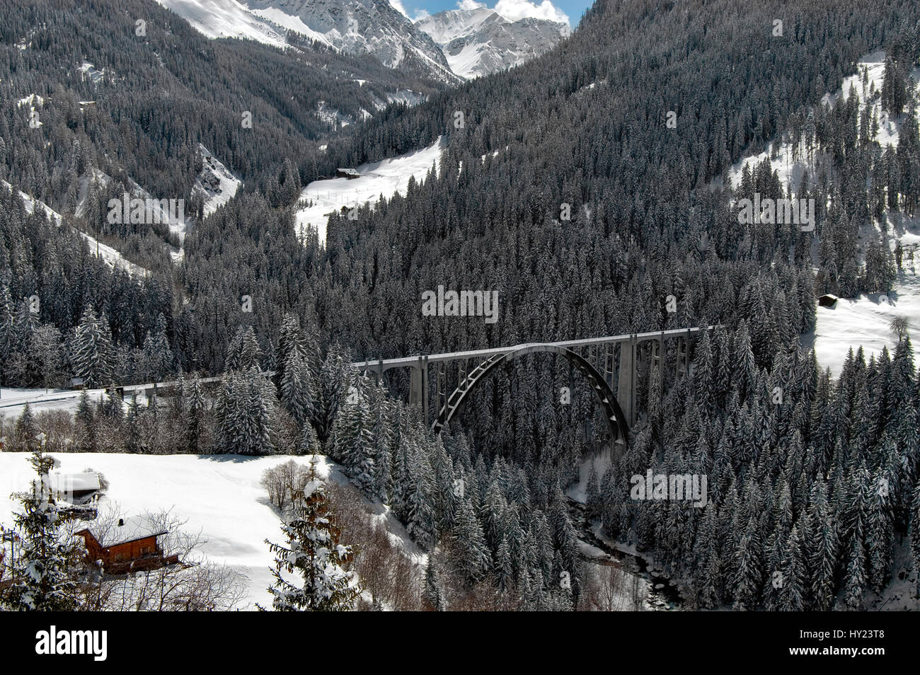 Langwies Viaduct Bridge in a beautiful mountain landscape near Arosa a ski resort in Switzerland. The image was taken on a sunny late winter afternoon Stock Photo