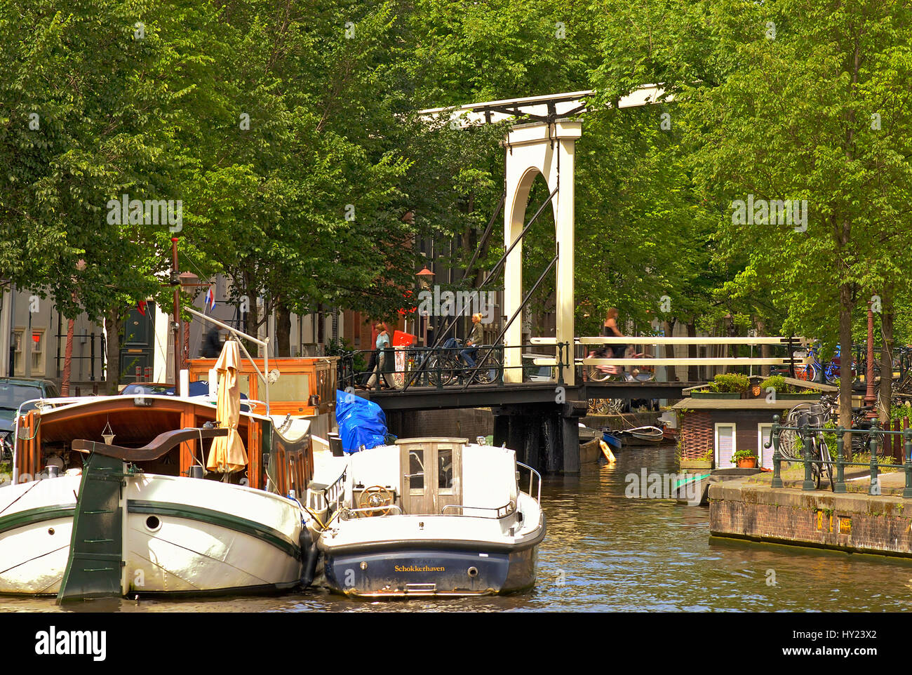 Image of house boat in a water channel in the inner city of Amsterdam, Holland. Stock Photo