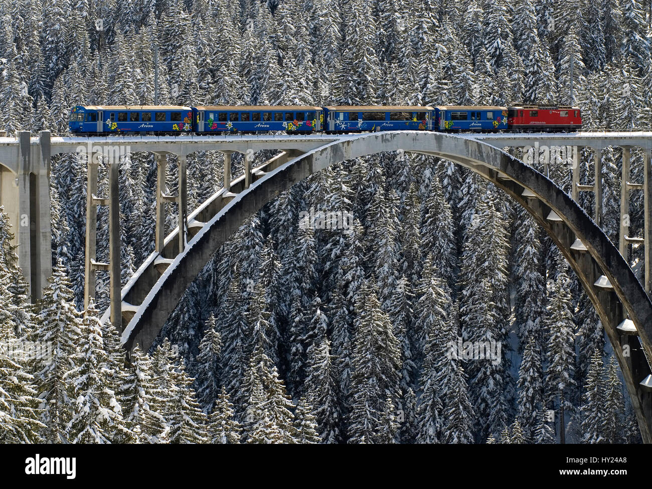 This stock photo shows the Arosa train on the Langwies Bridge in a beautiful mountain landscape near Arosa a ski resort in Switzerland. The image was  Stock Photo