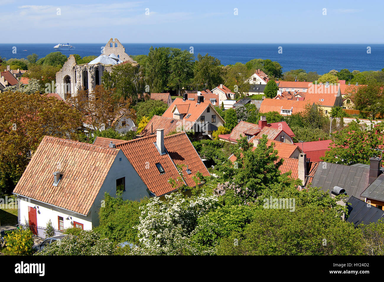 The Stock Photo shows a view over the red roofs of the Harbor town of Visbyon the Island of Gotland in Sweden. The image was taken from the top of the Stock Photo