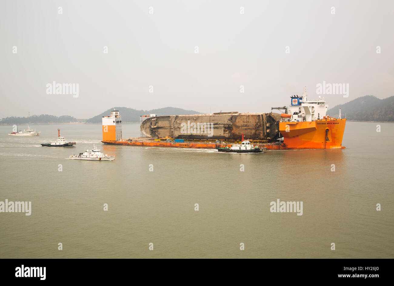 Mokpo, South Korea. 31st March 2017. South Korea's Coast Guard vessels escort semi-submersible ship Dockwise White Marlin carrying Sewol Ferry en route to Mokpo New Port in Mokpo, about 311 km (193 miles) south of Seoul, South Korea. The Sewol Ferry sailed into the port on Friday, about three years after it sank off South Korea's southwestern coast near Jindo on April 16, 2014 during a journey from Incheon to Jeju. The Ferry was carrying 475 crew and passengers, mostly high school students on a school trip. Credit: Aflo Co. Ltd./Alamy Live News Stock Photo