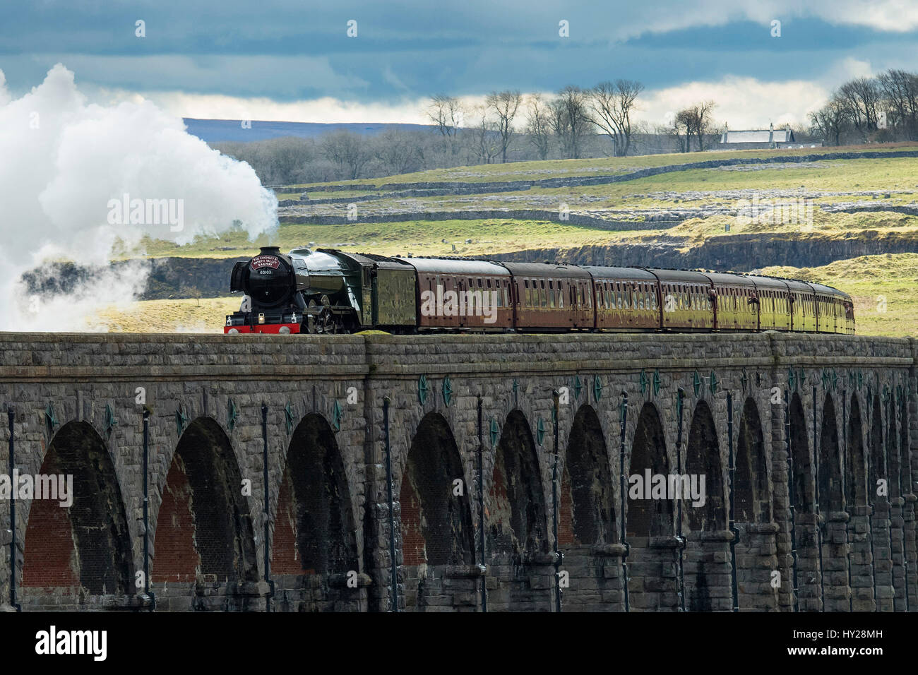 Ribblehead, North Yorkshire, UK. 31st March 2017. The iconic steam locomotive LNER class A3 60103 Flying Scotsman, travels over the Ribblehead Viaduct. The train is travelling this route, taking part in the celebrations marking  the re-opening of the Settle Carlisle line. Credit: Ian Lamond/Alamy Live News Stock Photo