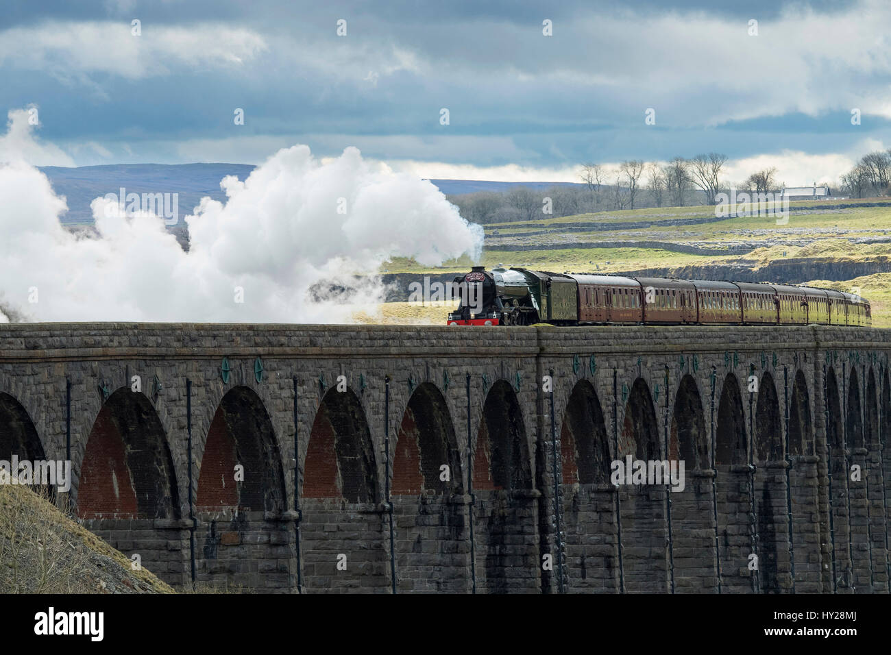 Ribblehead, North Yorkshire, UK. 31st March 2017. The iconic steam locomotive LNER class A3 60103 Flying Scotsman, travels over the Ribblehead Viaduct. The train is travelling this route, taking part in the celebrations marking  the re-opening of the Settle Carlisle line. Credit: Ian Lamond/Alamy Live News Stock Photo