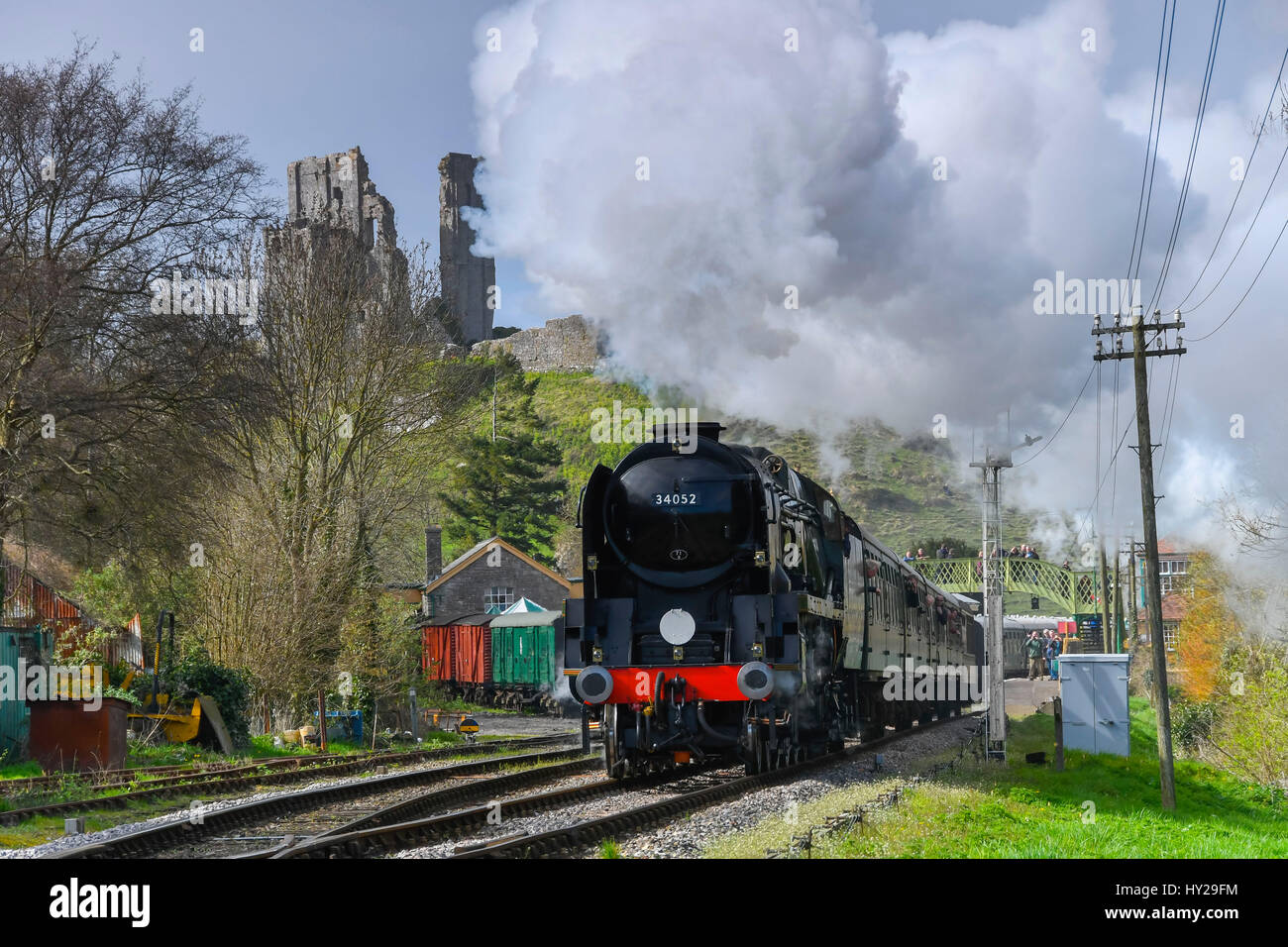Corfe Castle, Dorset, UK. 31st Mar, 2017. The Swanage Railway hosting a steam gala over 3 days with Bulleid locomotives to celebrate the 50th anniversary of the final operation of steam hauled service on British Railways Southern Region. Pictured is the locomotive 34052 Lord Dowding leaving Corfe Castle station in spectacular fashon with the ruins of the castle in the distance. Photo Credit: Graham Hunt/Alamy Live News Stock Photo