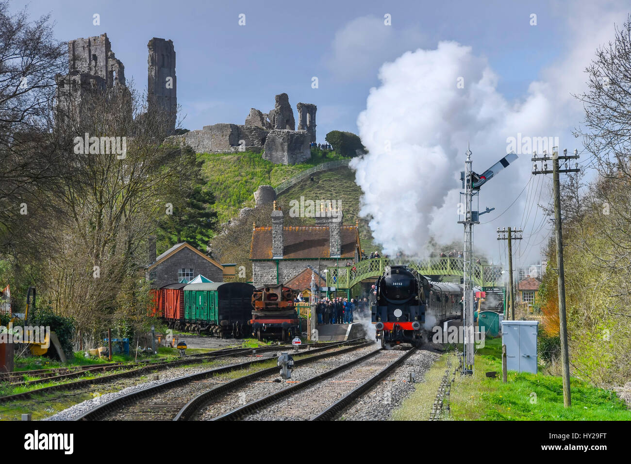 Corfe Castle, Dorset, UK. 31st Mar, 2017. The Swanage Railway hosting a steam gala over 3 days with Bulleid locomotives to celebrate the 50th anniversary of the final operation of steam hauled service on British Railways Southern Region. Pictured is the locomotive 34052 Lord Dowding leaving Corfe Castle station in spectacular fashon with the ruins of the castle in the distance. Photo Credit: Graham Hunt/Alamy Live News Stock Photo