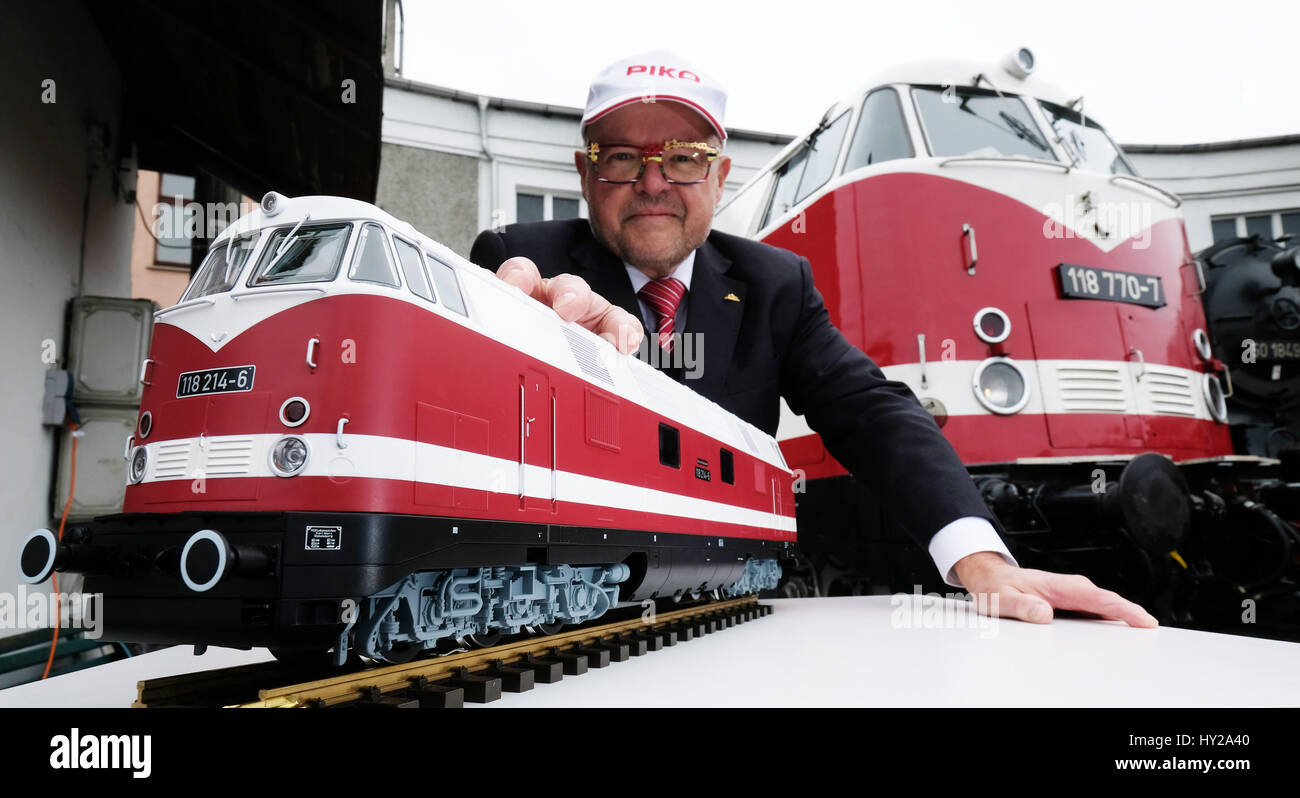 Rene Wilfer, managing director and proprietor of Piko Spielwaren GmbH toy  company between a model of a BR 118 diesel locomotive train and an original  version. The 118 series train was the
