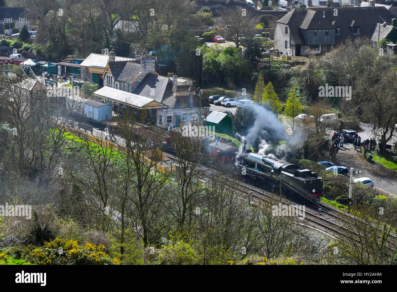 Corfe Castle, Dorset, UK. 31st Mar, 2017. The Swanage Railway hosting a steam gala over 3 days with Bulleid locomotives to celebrate the 50th anniversary of the final operation of steam hauled services on British Railways Southern Region. Pictured is the locomotives 34052 Lord Dowding in Corfe Castle station at the head of a freight train. Photo Credit: Graham Hunt/Alamy Live News Stock Photo