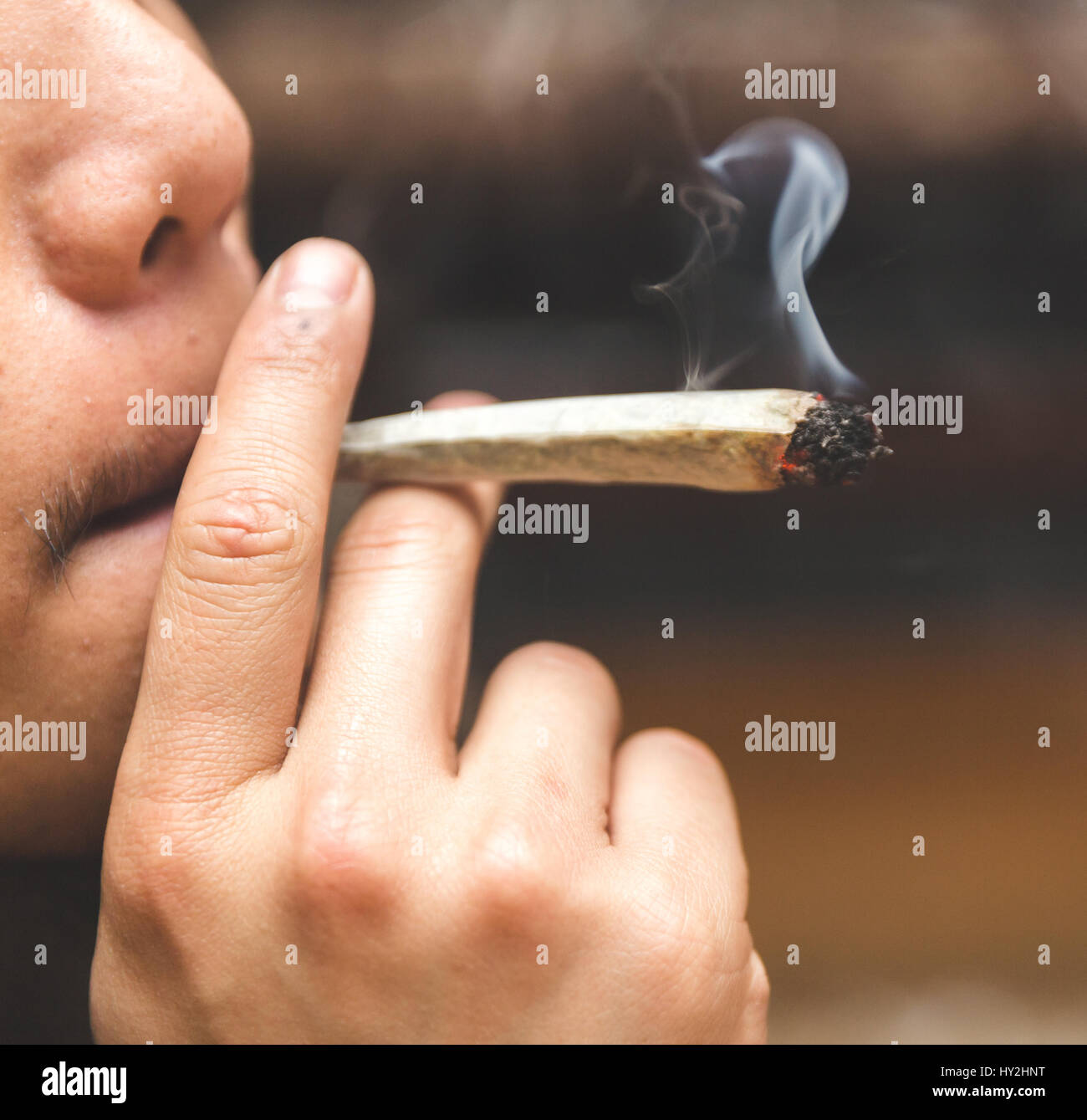 Man smoking joint, cigarette, or spliff Stock Photo Alamy