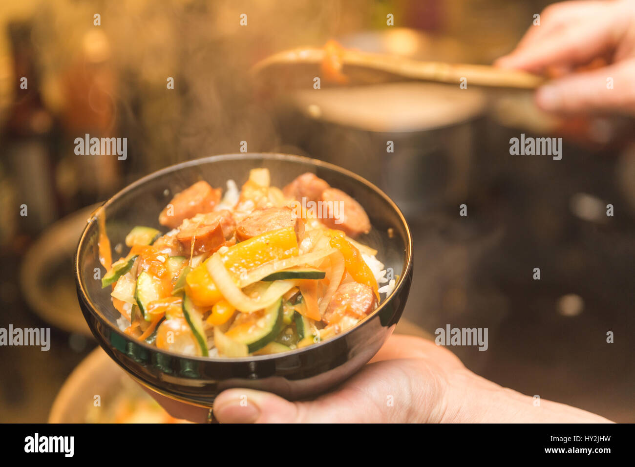 Rice, vegetables, and meat in freshly cooked meal. Stock Photo