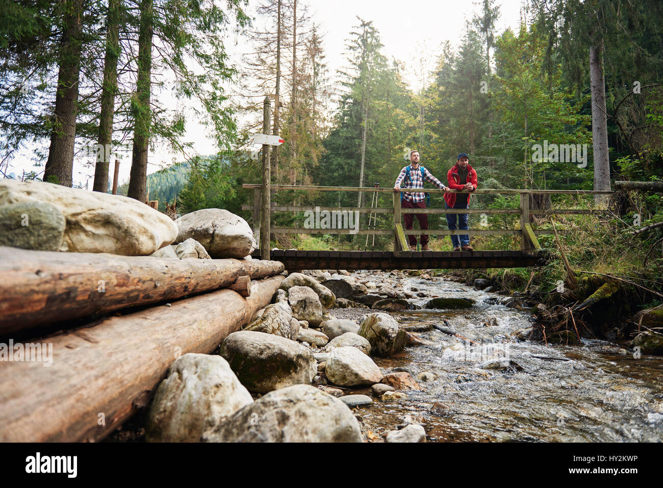 Hikers crossing bridge river hi-res stock photography and images - Alamy