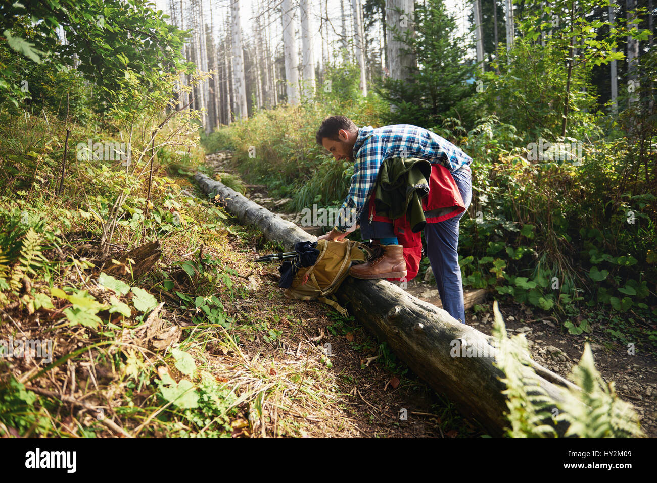 Young man preparing for a trek in the forest Stock Photo