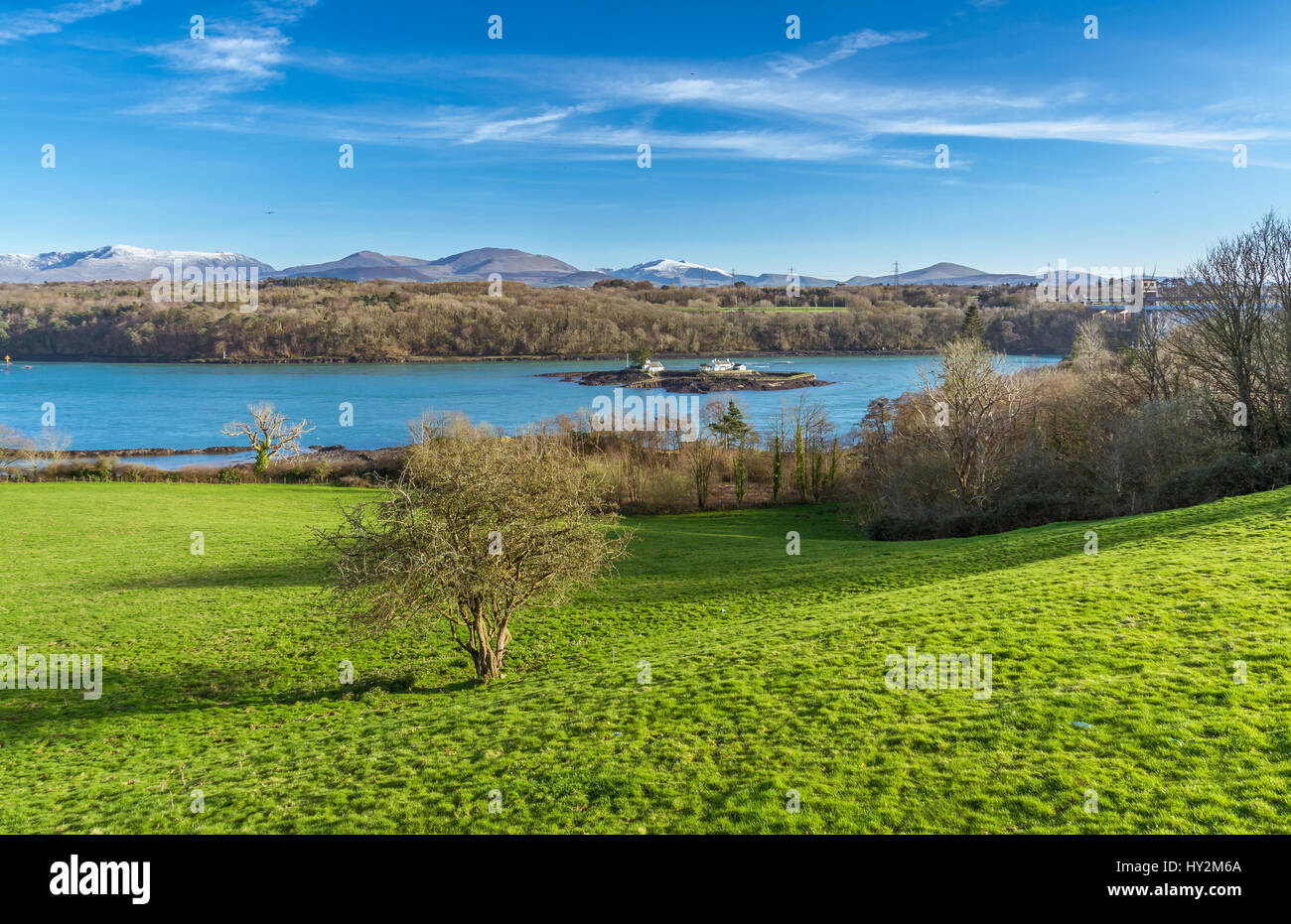 A view across the Menai Strait from a vantage point on Anglesey, with the Snowdonia mountains in