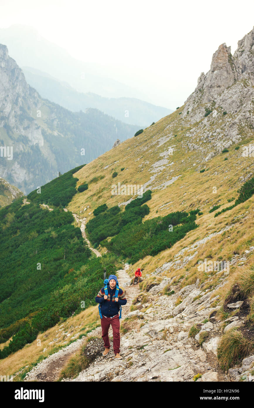 Hikers making their way up a rugged mountain trail Stock Photo