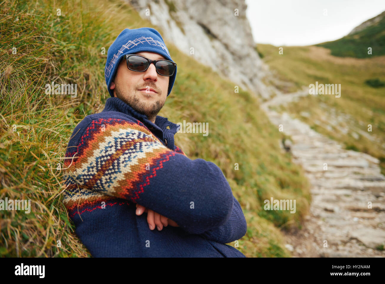 Hiker looking cool on a rugged mountain trail Stock Photo