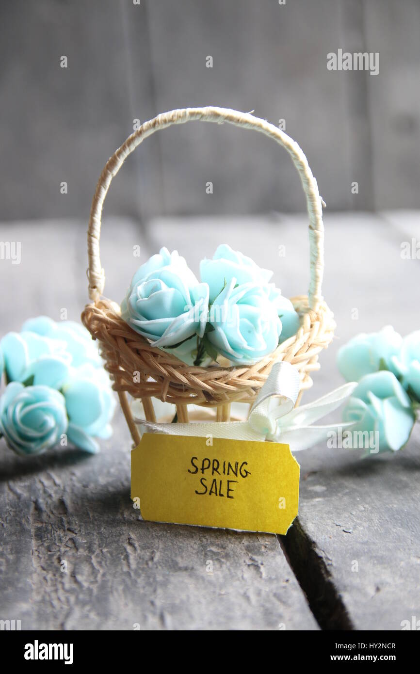 spring sale tag and flowers in a small basket Stock Photo - Alamy