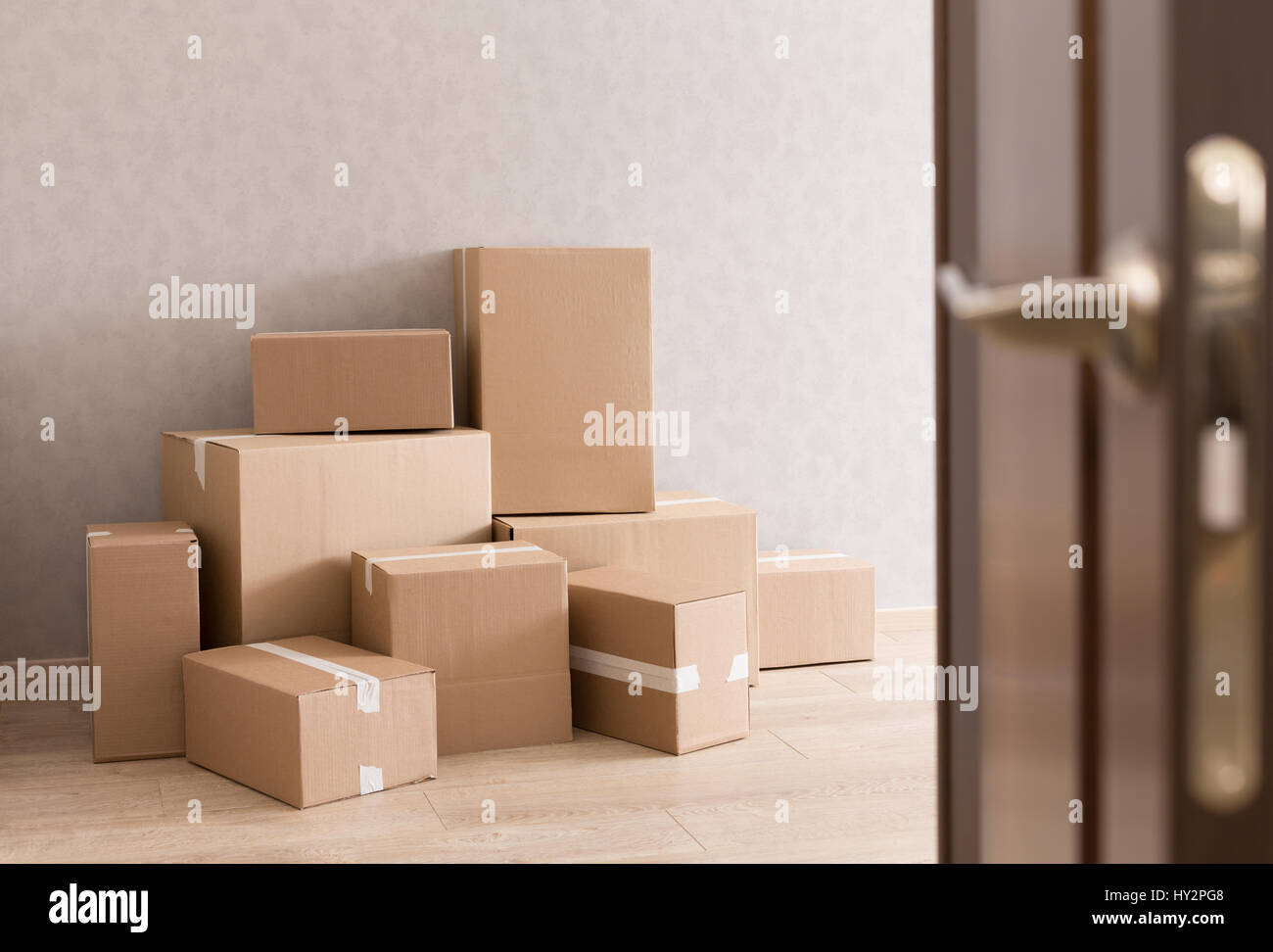 Moving boxes pile in doorway Stock Photo