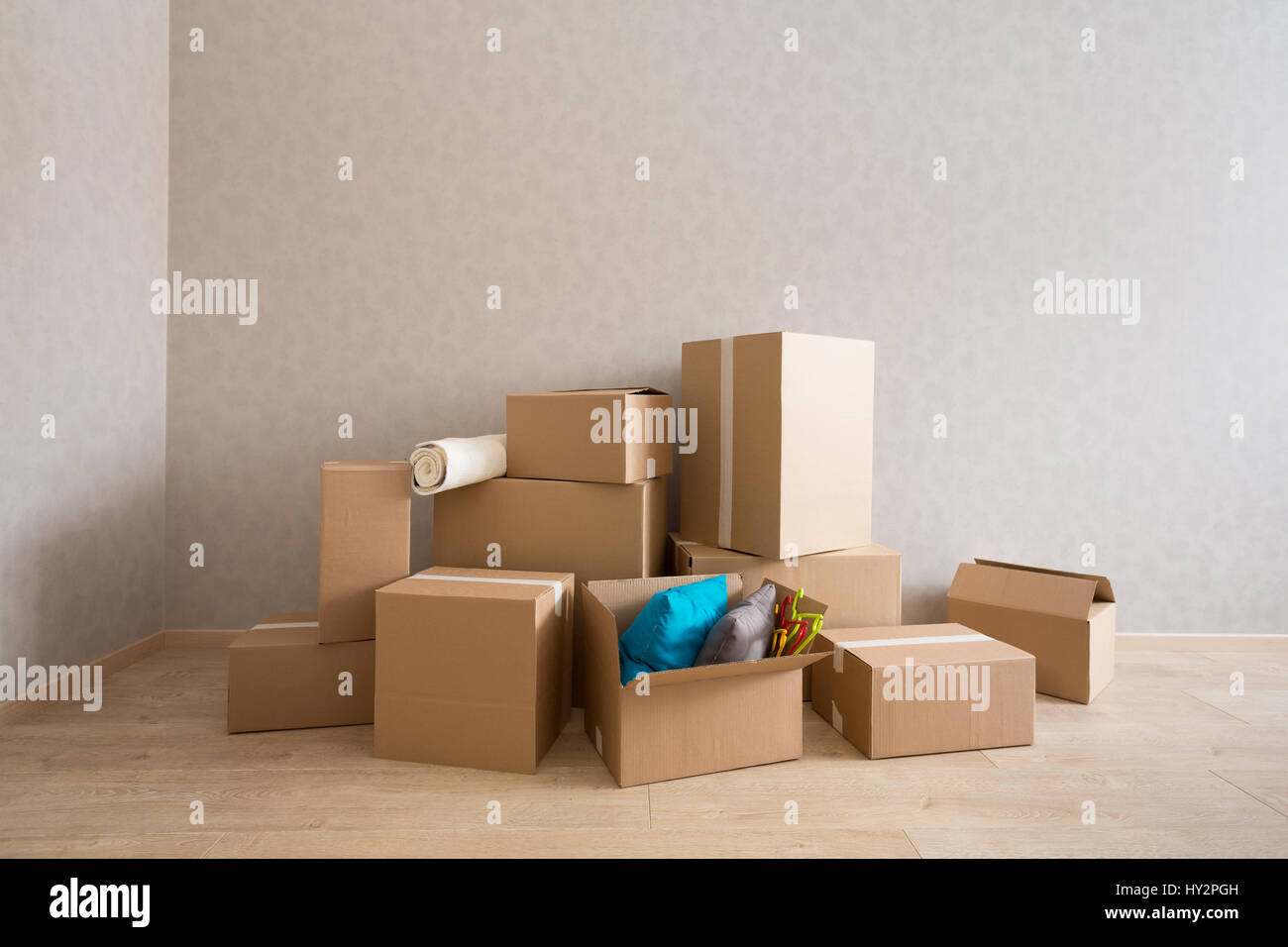 Cardboard boxes in new empty room Stock Photo