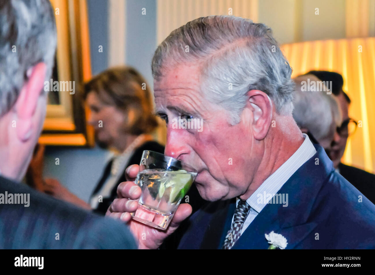 HILLSBOROUGH, NORTHERN IRELAND. 24 MAY 2016: HRH Prince Charles, the Prince of Wales, chats to guests in Hillsborough Palace over a gin and tonic. Stock Photo