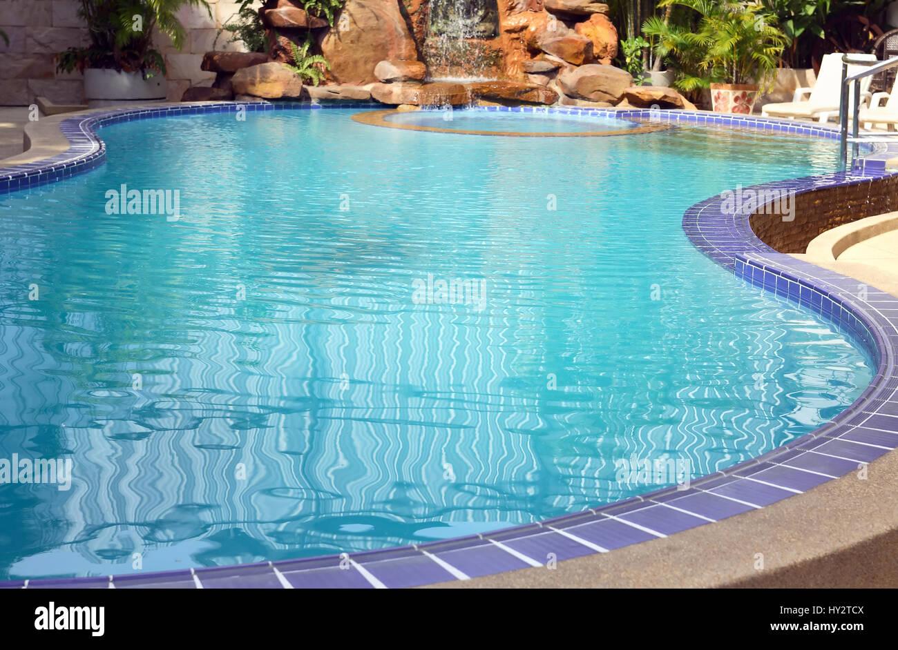 Closeup of elegant empty water pool with blue water near palm Stock ...