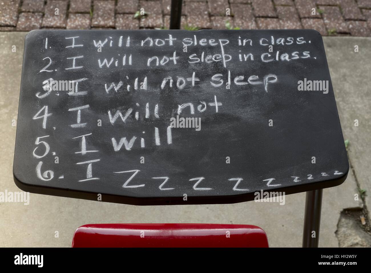 An old school desk brings back memories of the early grades in school. Stock Photo