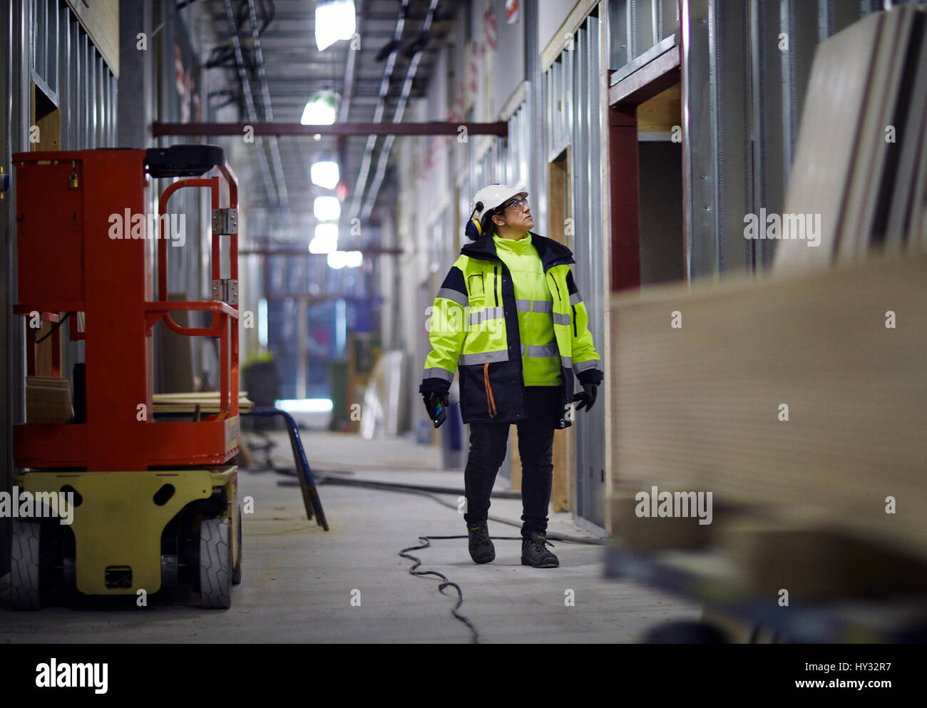 Sweden, Woman in protective clothing walking Stock Photo