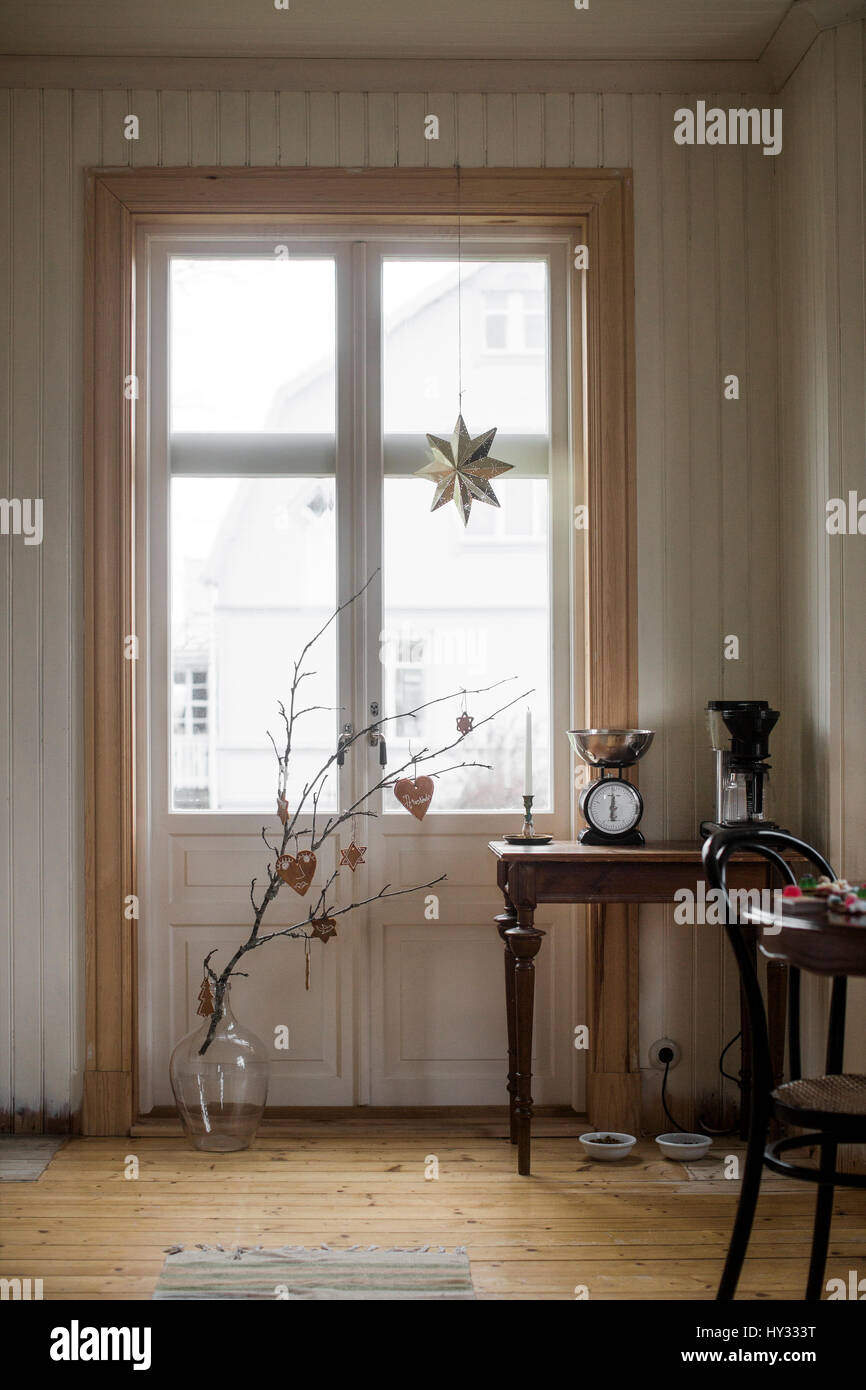 Sweden, Domestic room with branch in vase Stock Photo