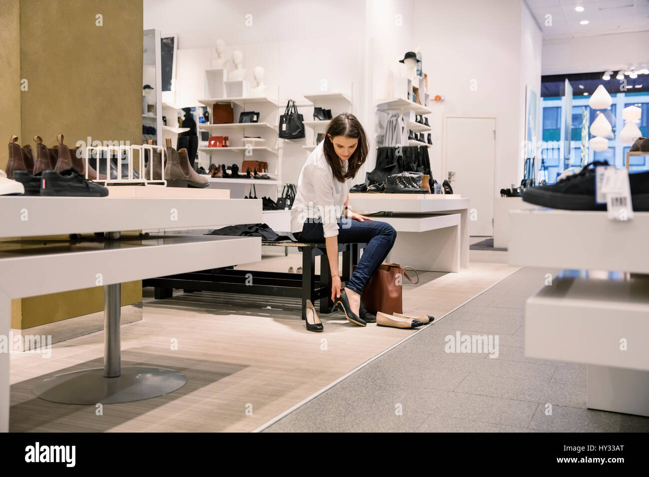 Woman trying on shoes in hires stock photography and images Alamy