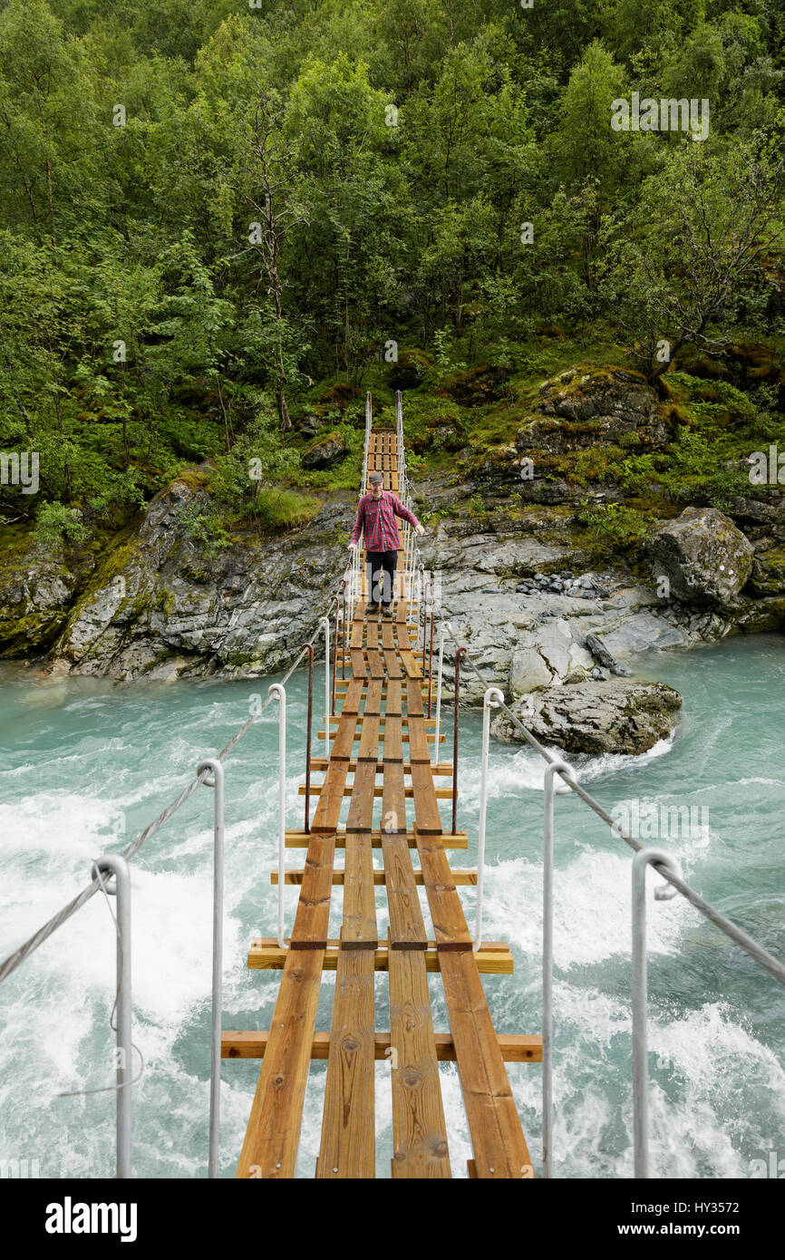 Man walking suspension bridge hi-res stock photography and images - Alamy