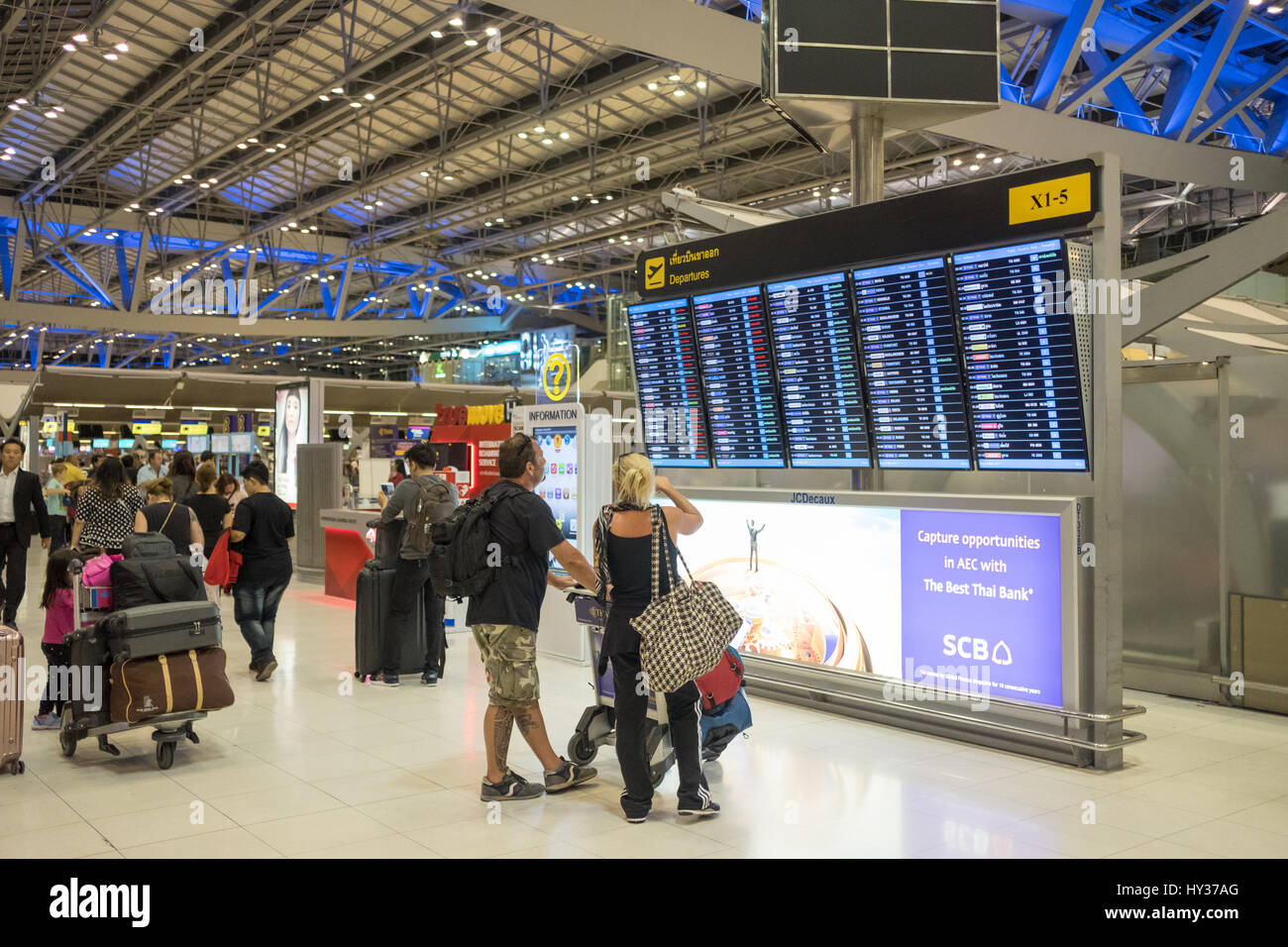 Travellers checking departures at Suvarnabhumi Airport in Bangkok. This