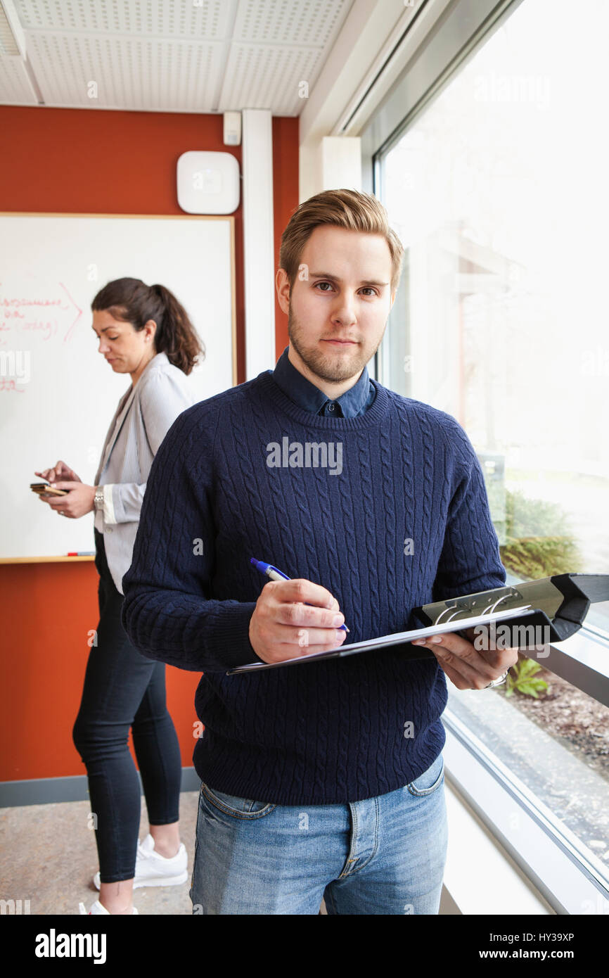 Sweden, Businessman holding ring binder in office Stock Photo