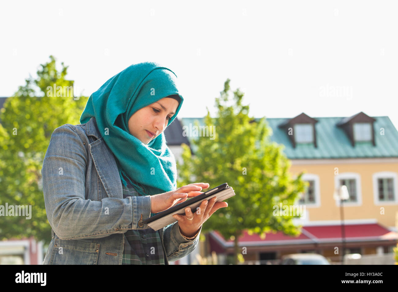 Sweden, Bleking, Solvesborg Muslim woman using tablet Stock Photo