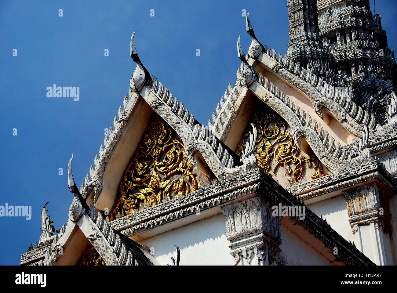 Phetchaburi, Thailand - January 3, 2010:  Phra Thinang Wichien Prasat with chofah ornaments and gilded tympanum leaf designs in front of the central P Stock Photo