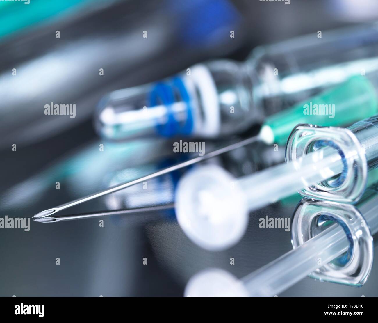 Close up of a syringe and vaccines on a surgical tray. Stock Photo
