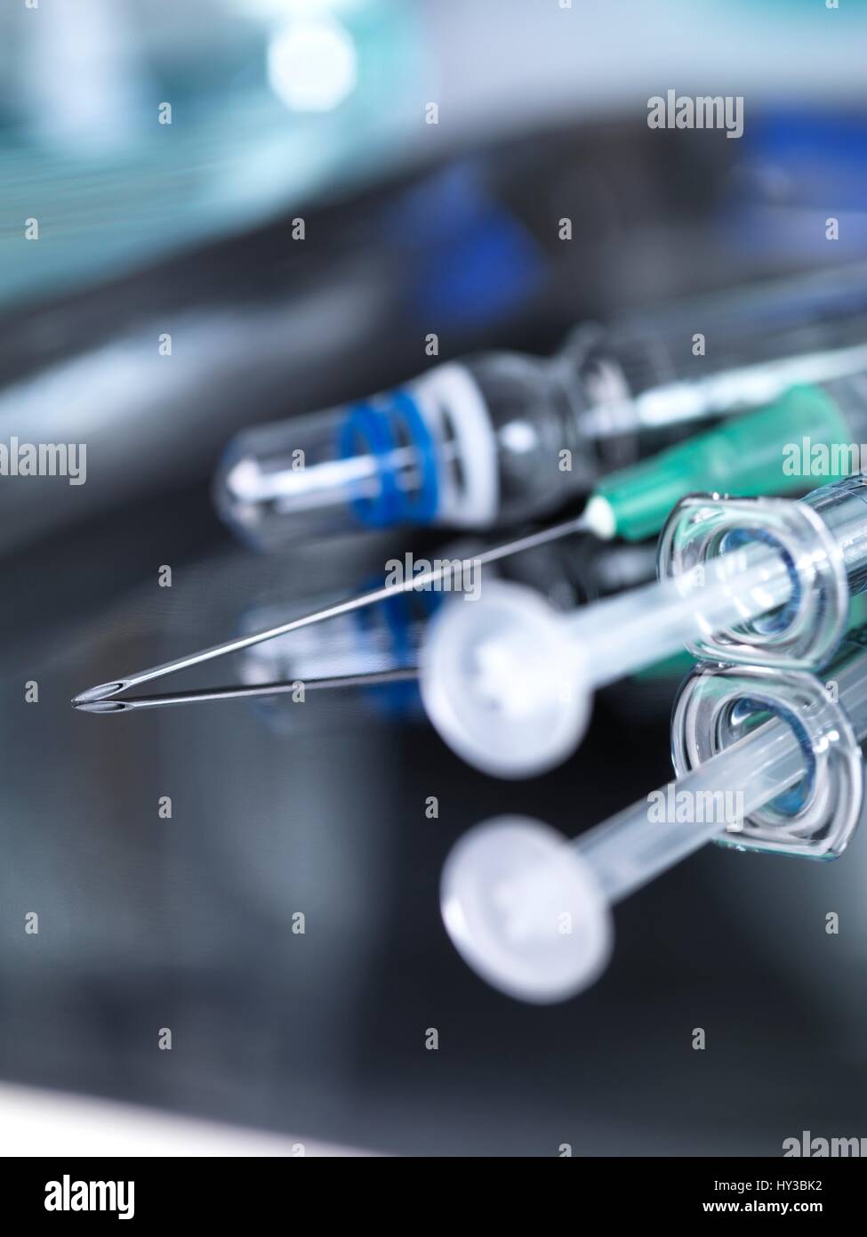 Close up of a syringe and vaccines on a surgical tray. Stock Photo