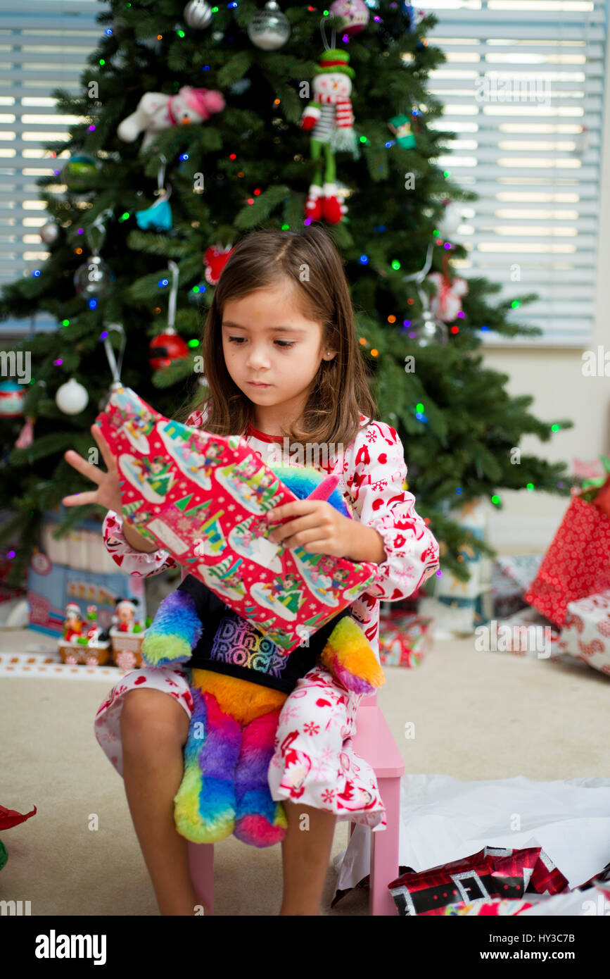 little girl holding Christmas presents Stock Photo - Alamy