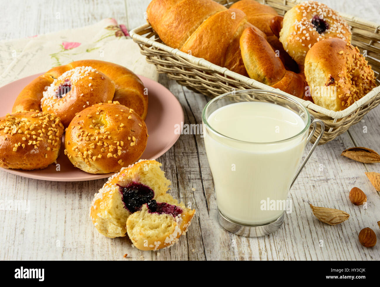 Healthy breakfast ingredients. Homemade fresh fragrant buns and milk . The food is rich in useful carbohydrates, vitamins and nutrients that are essen Stock Photo