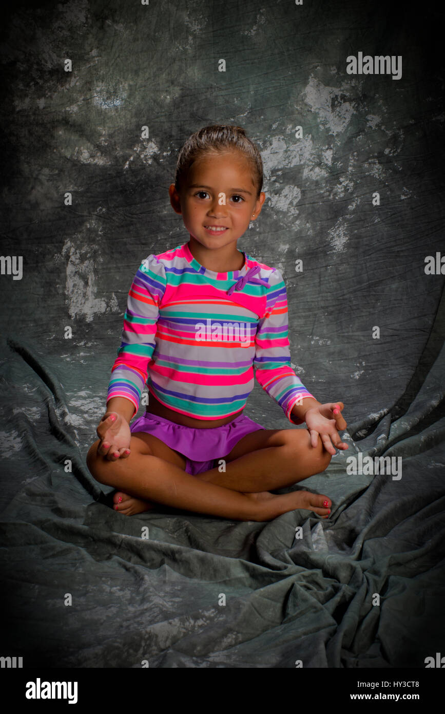 young girl in studio posing with grey background Stock Photo - Alamy