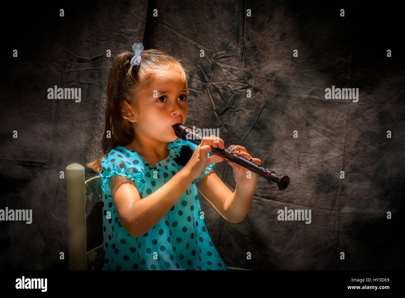 young girl playing flute Stock Photo