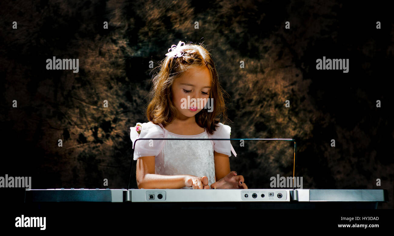 young girl with musical instrument keyboard Stock Photo