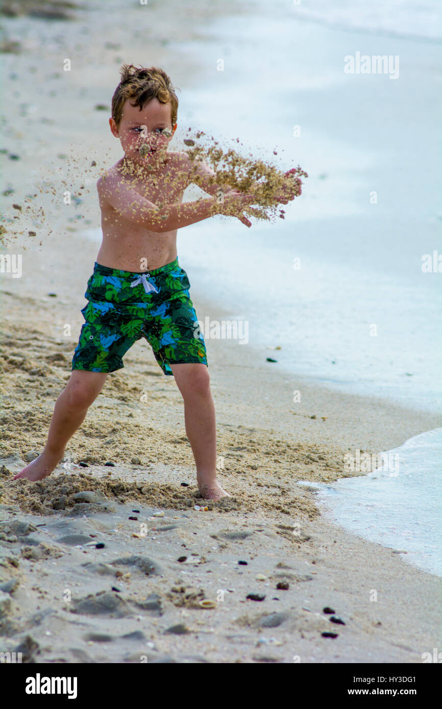 young boy at the beach playing in sand Stock Photo - Alamy