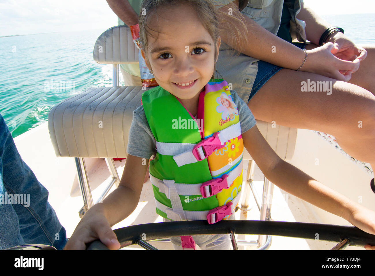 young girl driving a boat Stock Photo Alamy