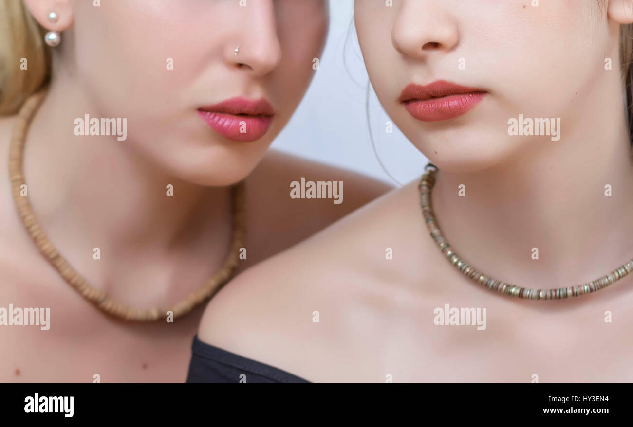 Close up of two young women lips over white background. Soft focus Stock Photo