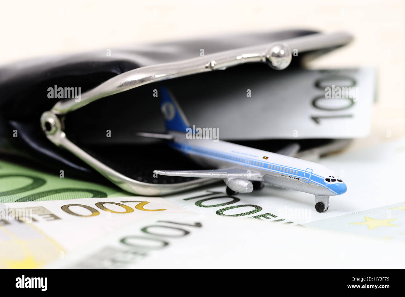 Miniature airplane in a change purse, symbolic photo aerial transfer tax, Miniaturflugzeug in einer Geldbörse, Symbolfoto Luftverkehrssteuer Stock Photo