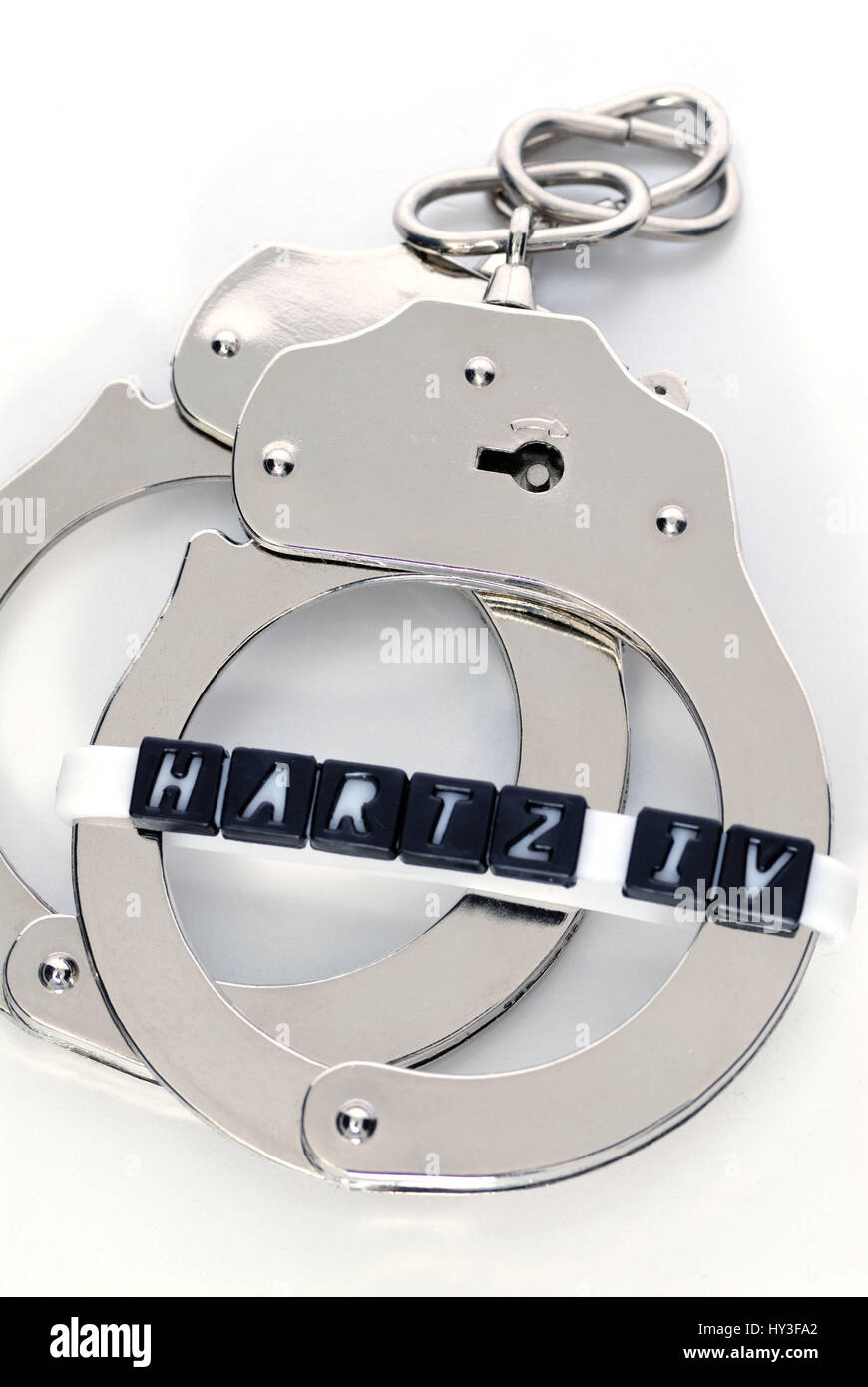 Handcuffs and Hartz IV stroke, working duty for Hartz IV receiver, Handschellen und Hartz IV-Schriftzug, Arbeitspflicht für Hartz IV-Empfänger Stock Photo