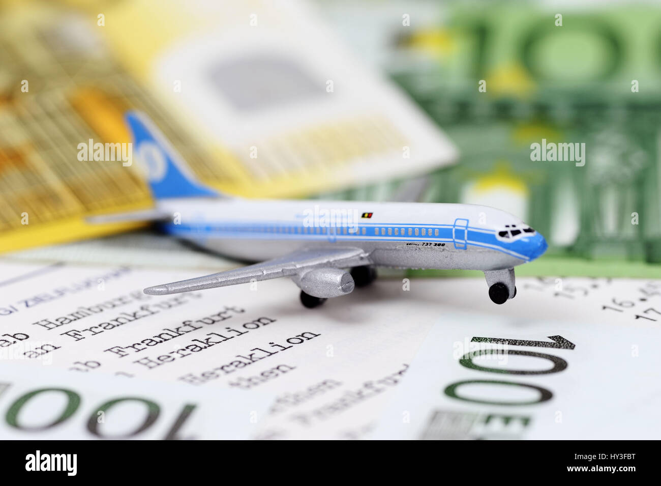 Miniature airplane and bank notes, symbolic photo aerial transfer tax, Miniaturflugzeug und Geldscheine, Symbolfoto Luftverkehrssteuer Stock Photo